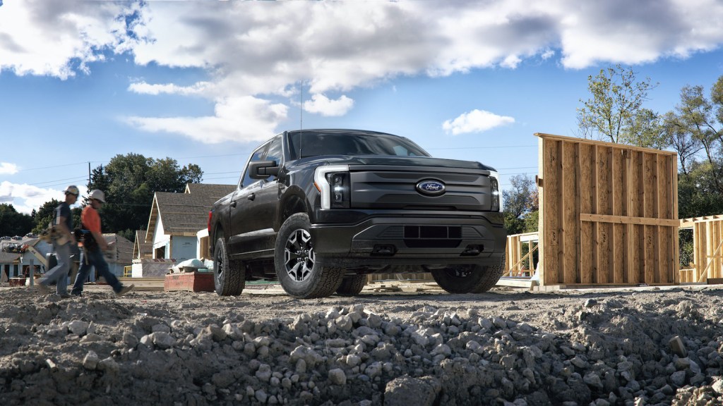 Publicity shot of a black 2022 Ford F-150 Lightning Pro. Pre-production model with available features shown. Available starting spring 2022. 
