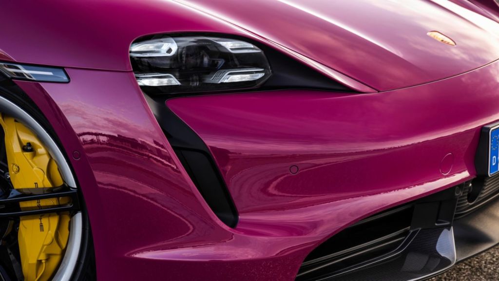The front of a hot pink 2022 Porsche Taycan.