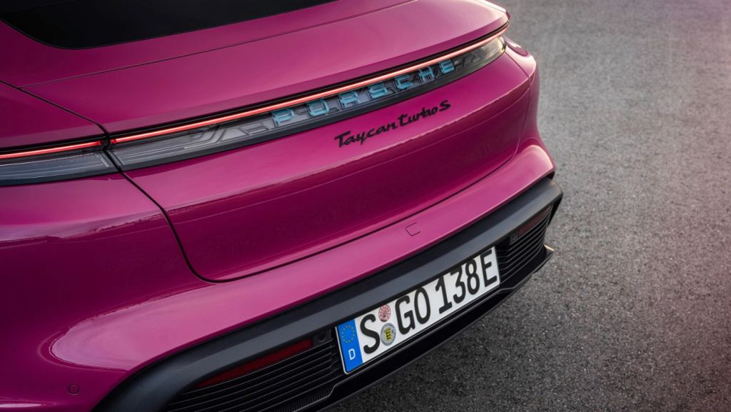 The back of a hot pink 2022 Porsche Taycan. 