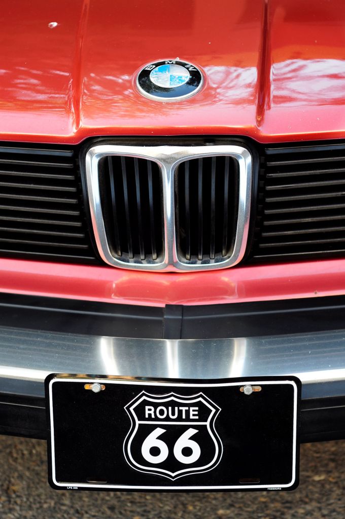 A Route 66 front license plate on a red classic BMW