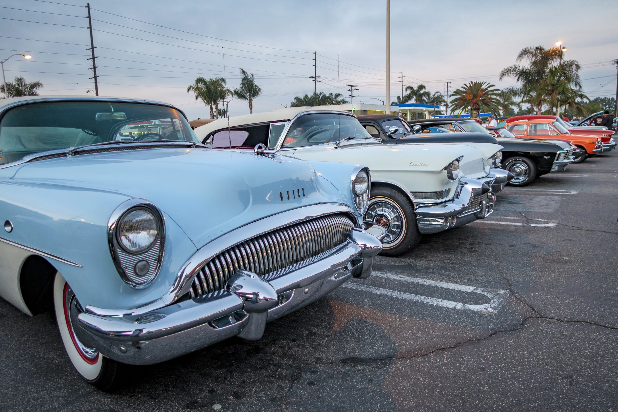 A Row Of Classic Cars Backed Into Parking Spaces
