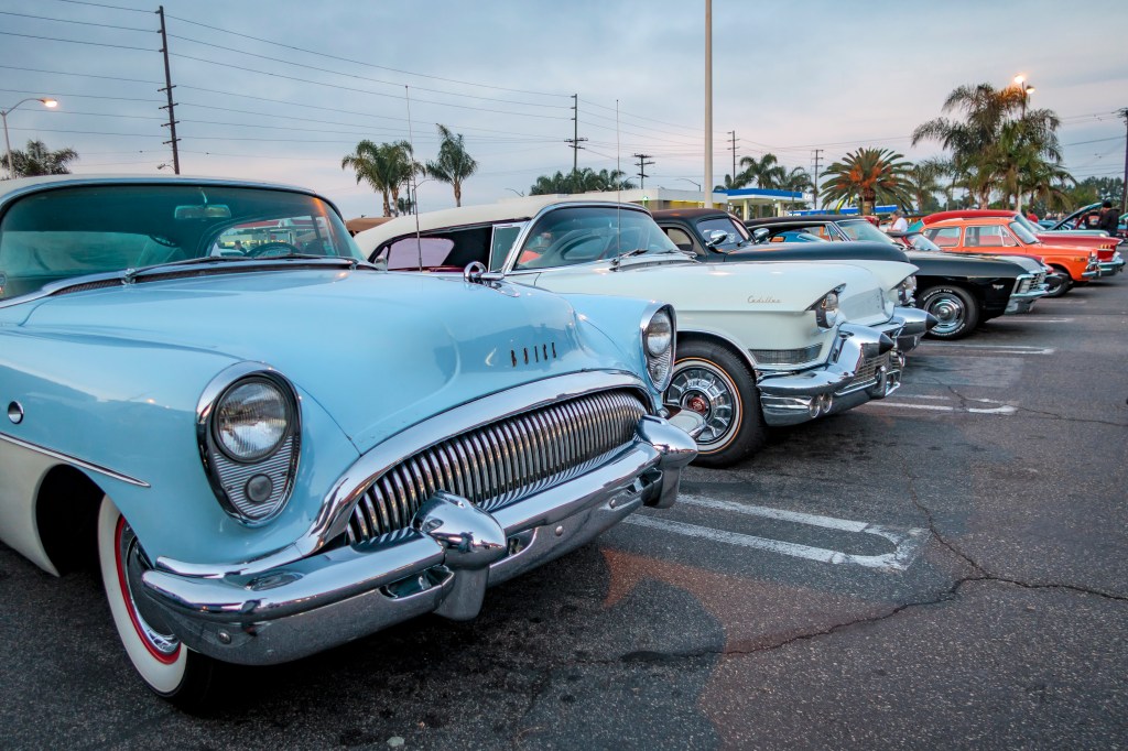 A Row Of Classic Cars Backed Into Parking Spaces