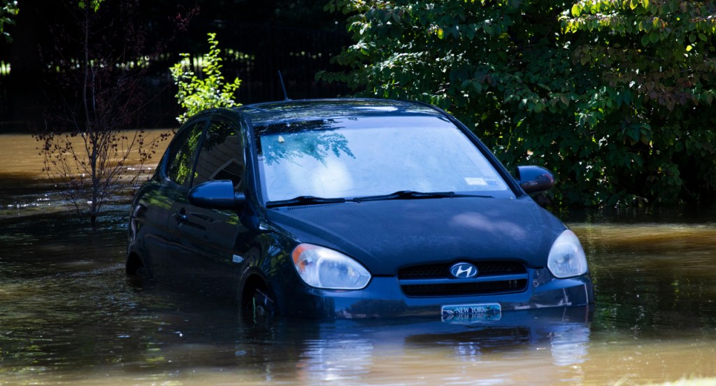 A car sits in a flooded parking spot after a night of high winds and rain from the remnants of Hurricane Ida.