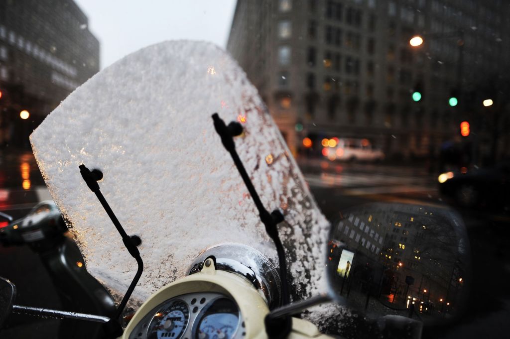 A snow-covered motorcycle windshield seen in Washington, DC