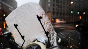 A snow-covered motorcycle windshield seen in Washington, DC