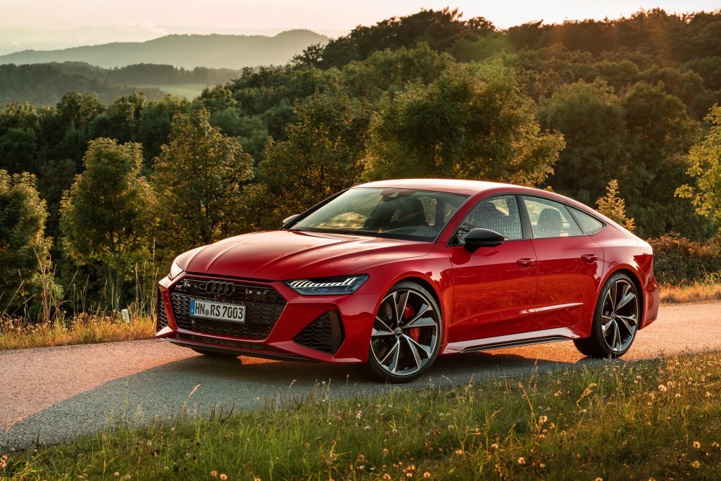 A red 2021 Audi RS7 shot from the high front 3/4 angle on a mountain road