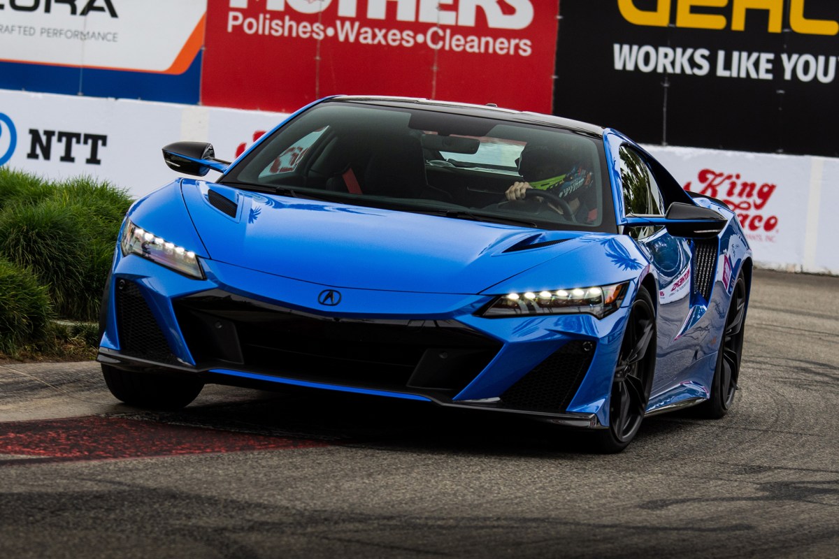 A blue Acura NSX Type S tackling a corner on the Grand Prix of Long Beach street circuit.