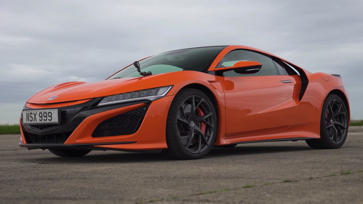 An orange Acura (Honda in Europe and Japan) NSX with a GoPro camera attached to its windshield as it prepares for a drag race.