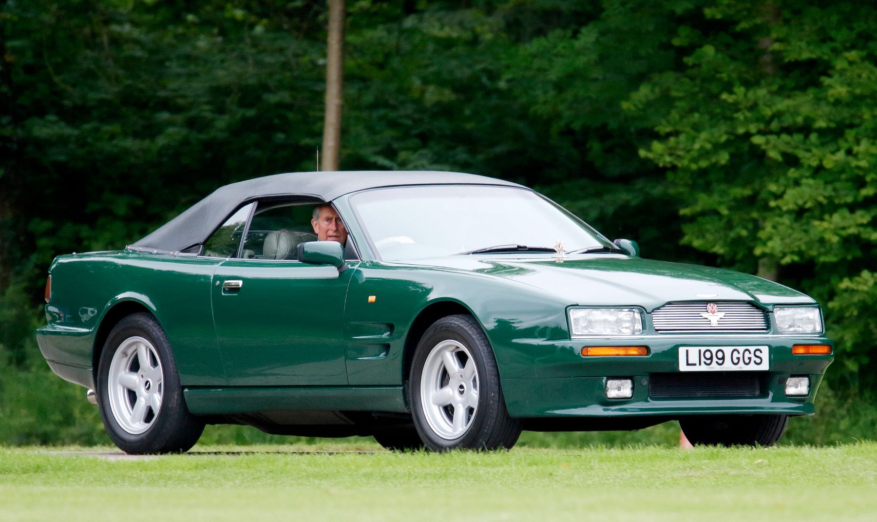 An Aston Martin Virage Volante model being driven by Prince Charles