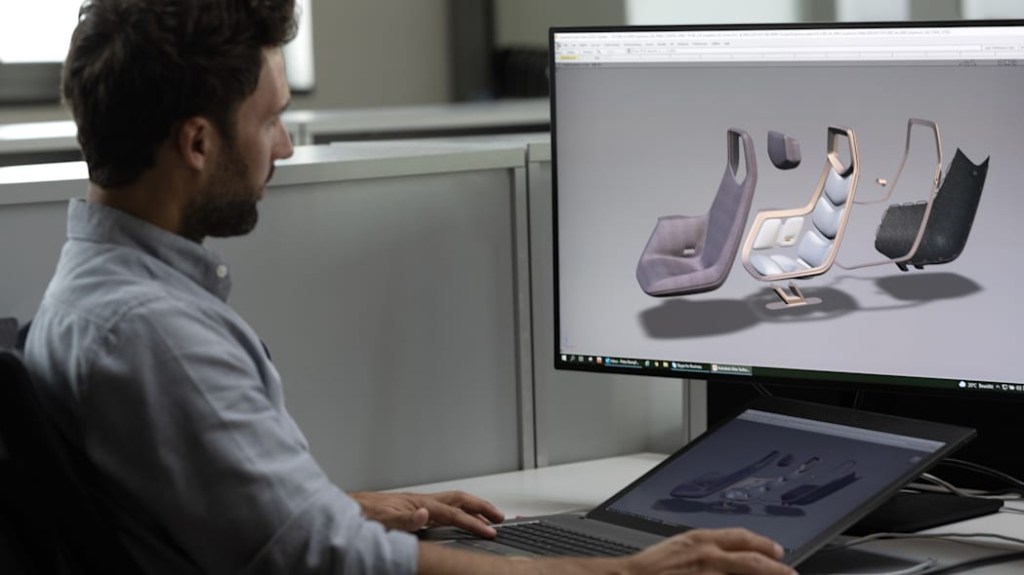 A man develops the BMW iVision Circular concept vehicle, putting together seats from recycled materials