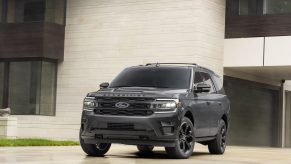 Black 2022 Ford Expedition Stealth Edition Performance Package parked in front of a white building