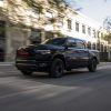 Black 2022 Ram 1500 Limited (RAM) RED Edition driving down a street