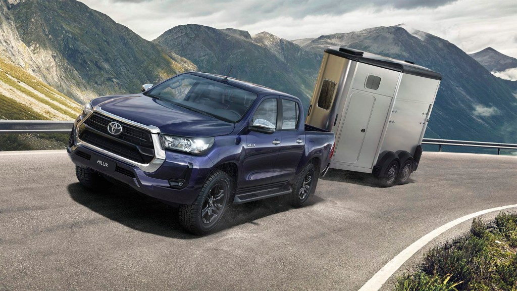 Blue 2021 Toyota Hilux towing a trailer
