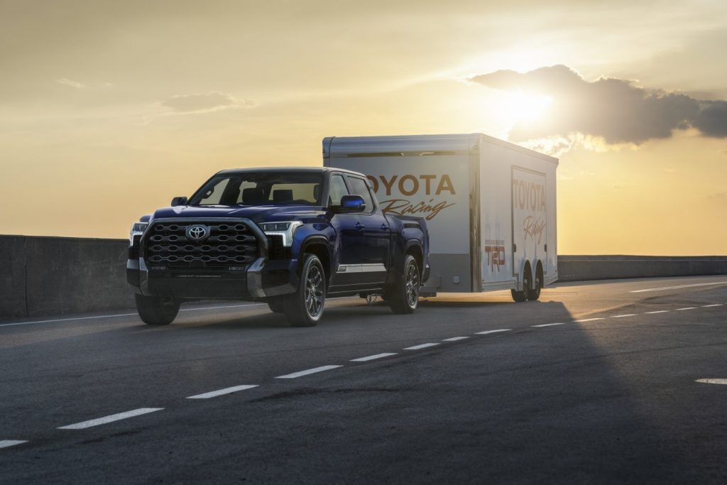 Blue 2022 Toyota Tundra towing a Toyota Racing trailer
