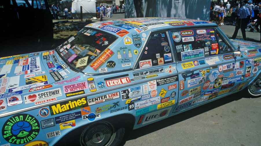 Blue car covered in bumper stickers