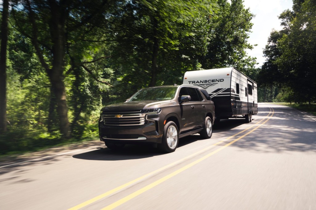 Brown 2021 Chevy Tahoe towing a camping trailer