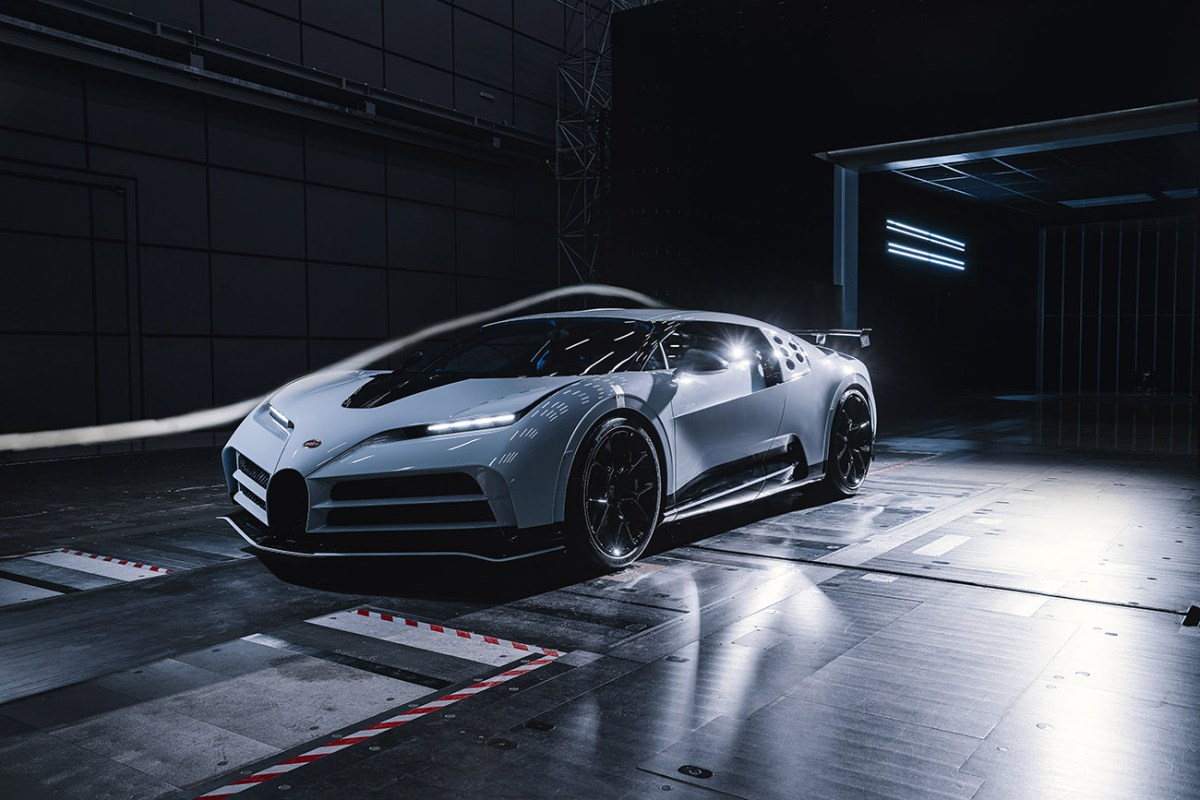A white Bugatti Centodieci inside of Bugatti's advanced wind tunnel facility undergoing an aerodynamic test.