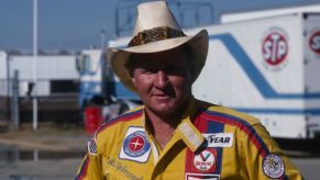 Cale Yarborough wearing a yellow shirt with carious branded patches.