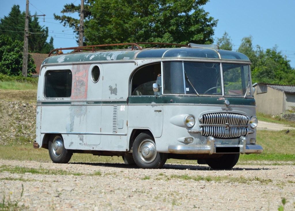 This Custom Citroen H Van is one of the coolest vintage campers we've ever seen. It shows a good bit of wear as it sits parked in a field  