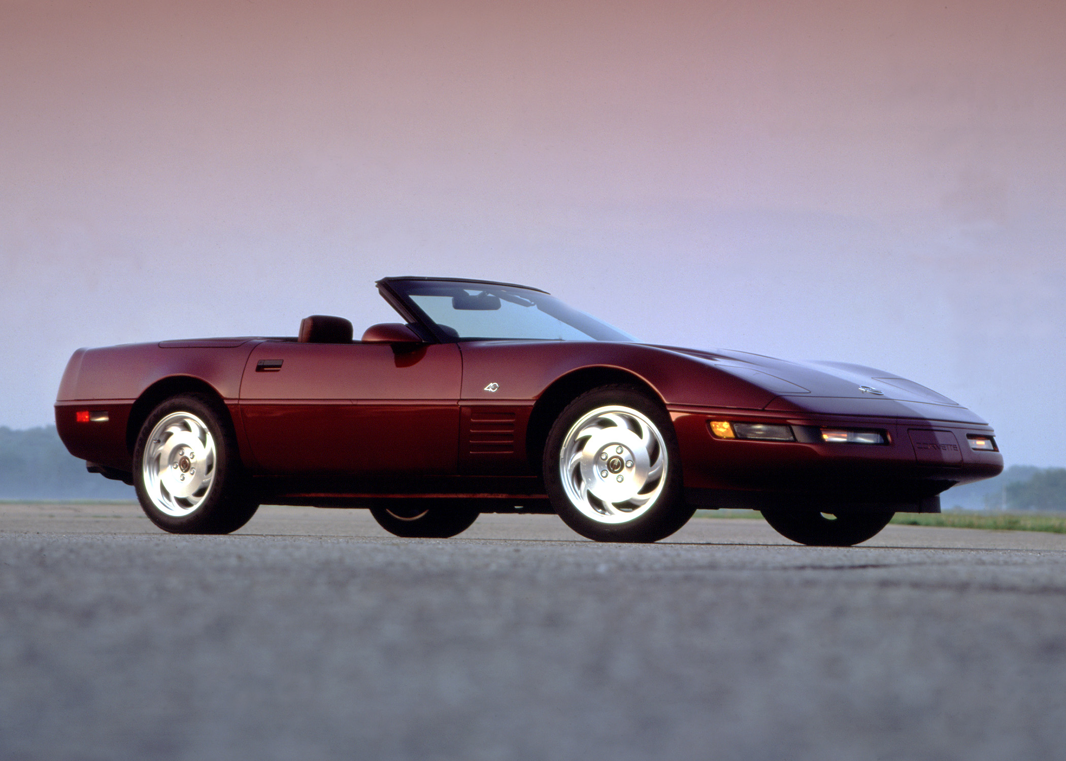 A maroon C4 Corvette was the American sports car of the '90s, seen here at the front 3/4 angle