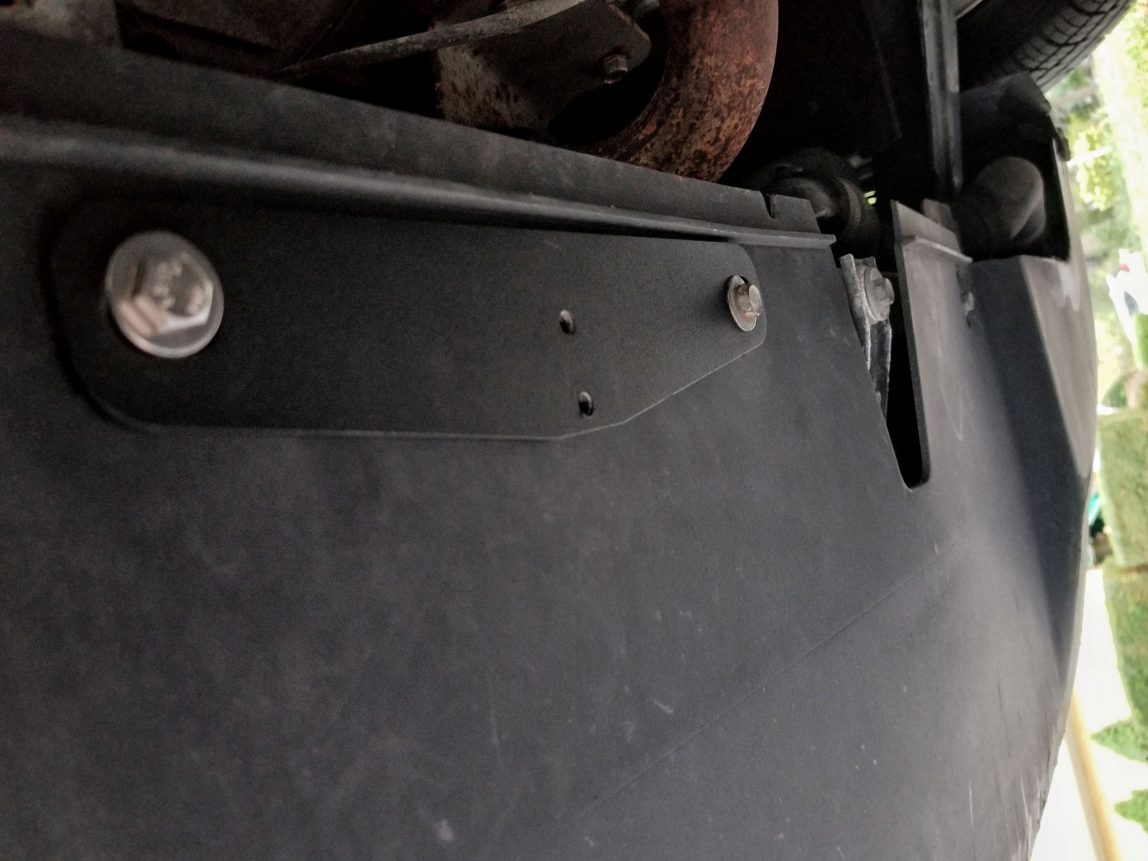 The CravenSpeed Platypus front license plate holder's base mount attached to a 2013 Fiat 500 Abarth's scrape protector