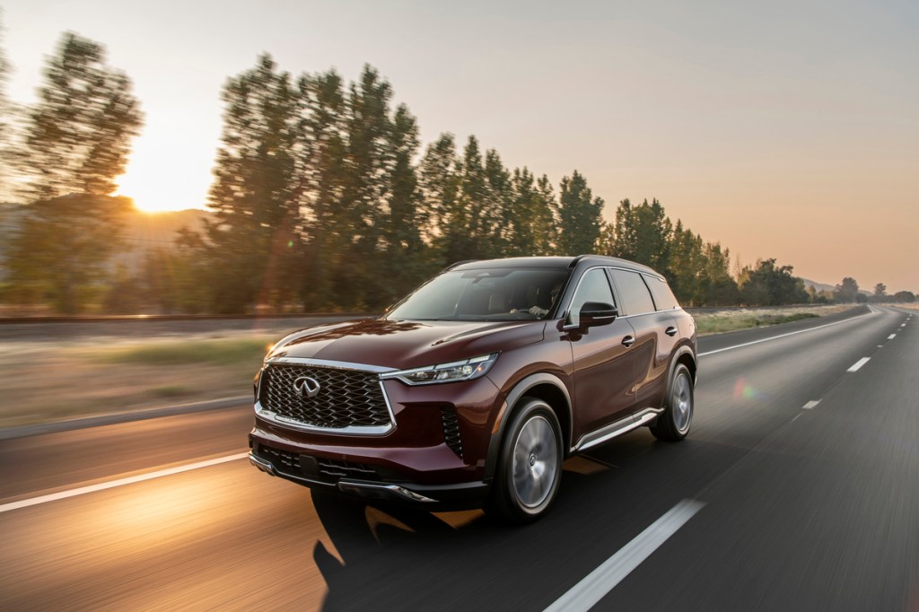 The 2022 INFINITI QX60 driving on the road at dusk