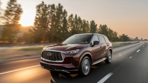 The 2022 INFINITI QX60 driving on the road at dusk