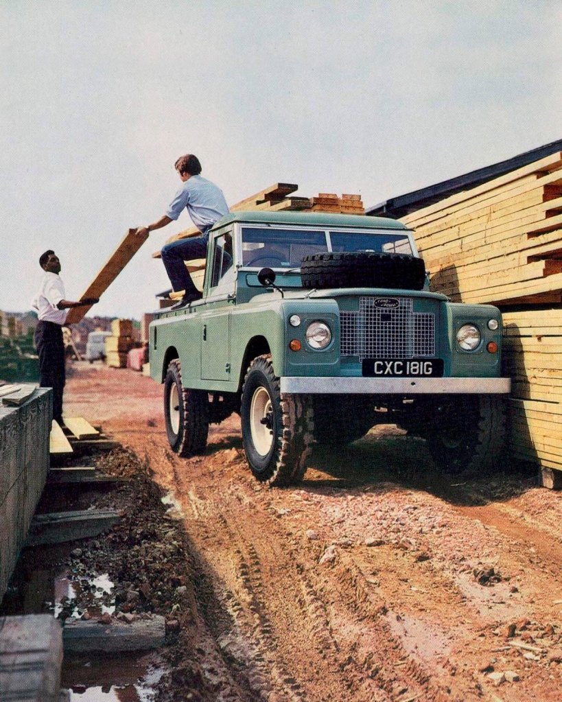 vintage advertisement for the original Land Rover Defender 110 1-ton on a construction site