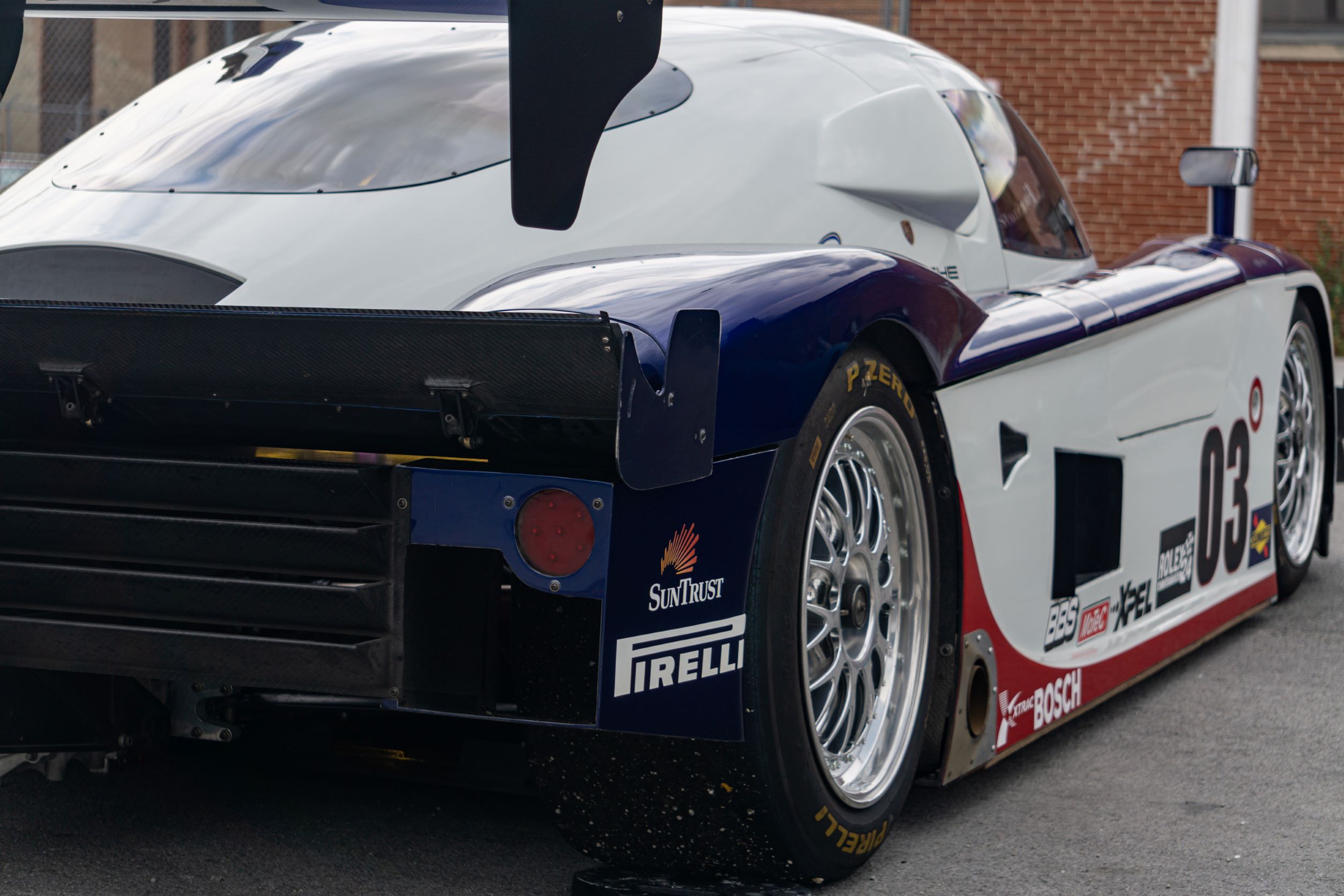 The rear 3/4 view of Fall-Line Motorsports' white-red-and-blue Porsche Crawford Daytona Prototype