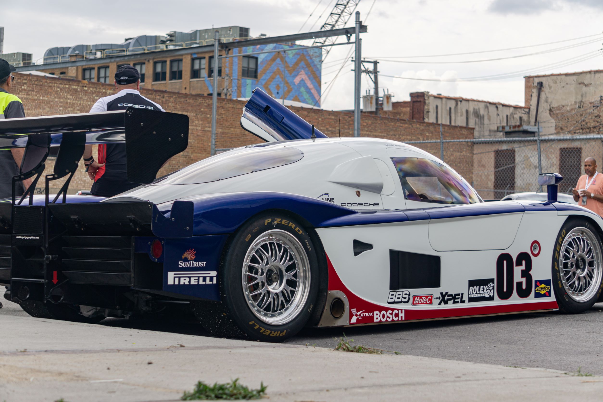 The side 3/4 view of a white-blue-and-red Fall-Line Motorsports' Porsche Crawford Daytona Prototype