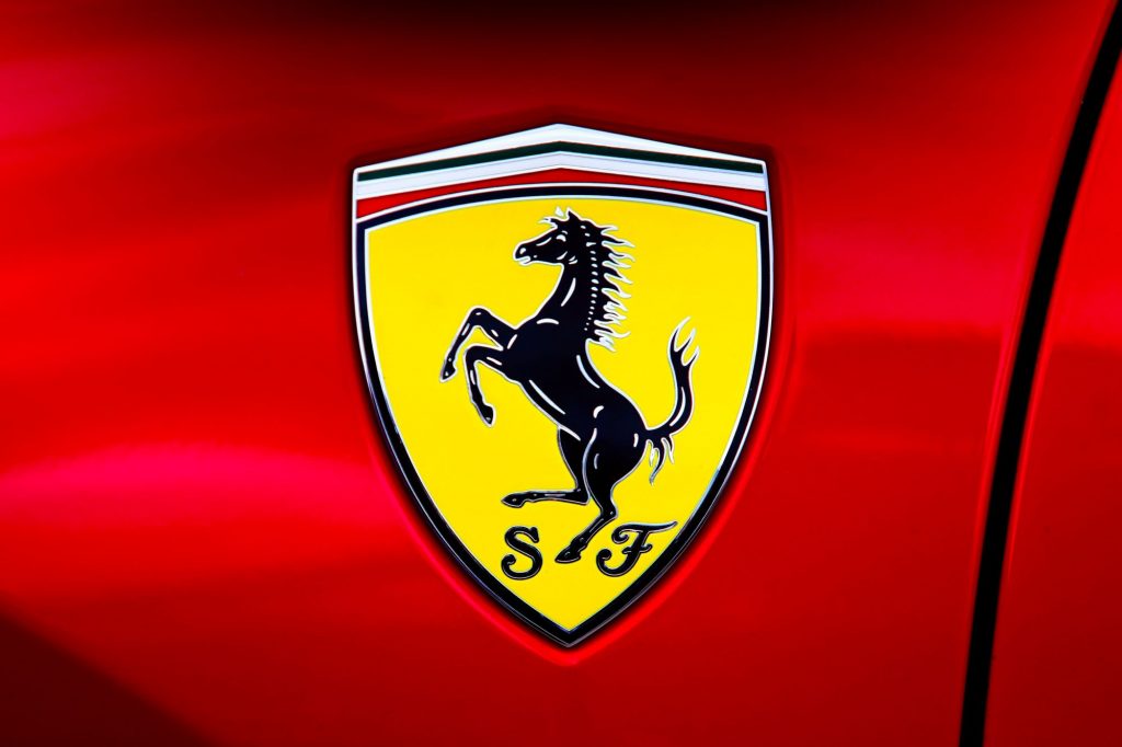 A yellow Ferrari logo on a red Ferrari model.