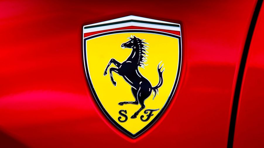A yellow Ferrari logo on a red Ferrari model.