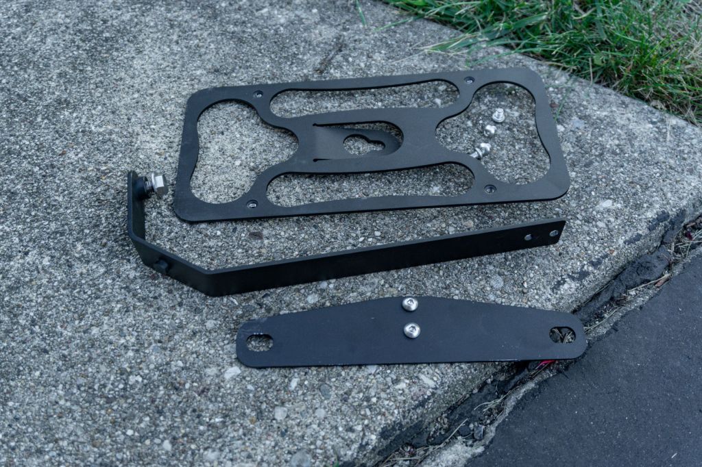 The components of CravenSpeed's Fiat 500 Abarth Platypus front license plate holder