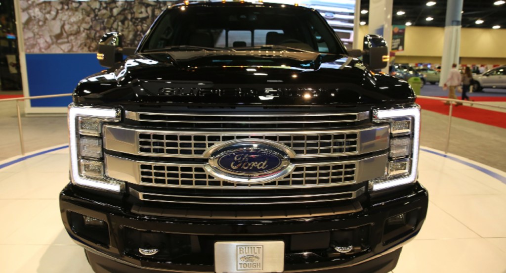 A black Ford F-250 heavy duty truck is on display. 
