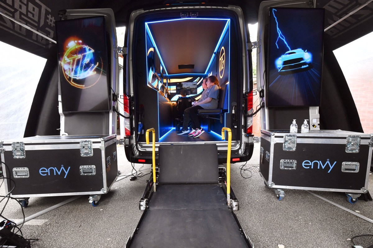 Team Fordzilla Gaming Transit van shot from the rear with the doors open to reveal the interior gaming suites and wheelchair lift.