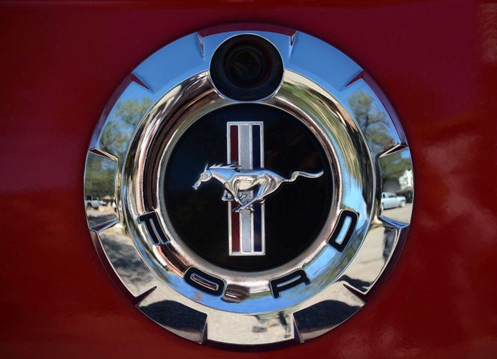 Makers of the Ford Mustang Shelby logo on a red car.