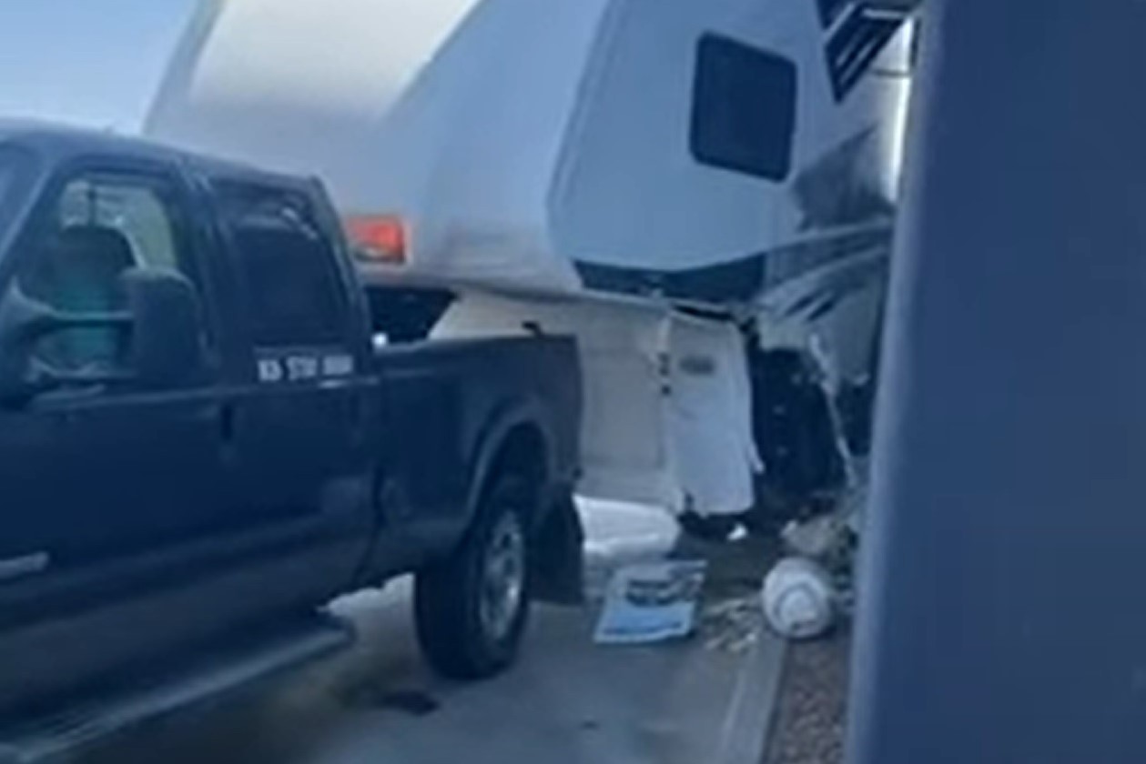 A Ford Super Duty towing a trailer through the drive through and nearly completely destroyed it.