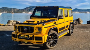 Front view of yellow and black Mercedes-Benz G-Class G-Boss parked in front of a lake