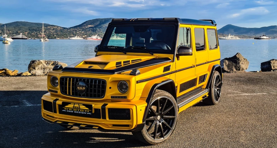 Front view of yellow and black Mercedes-Benz G-Class G-Boss parked in front of a lake