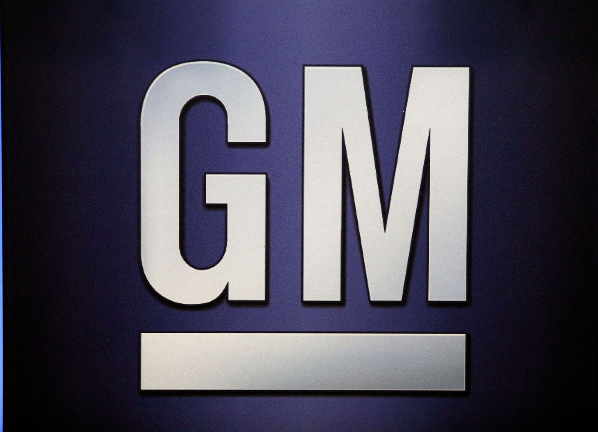 A white GM logo against a blue background.