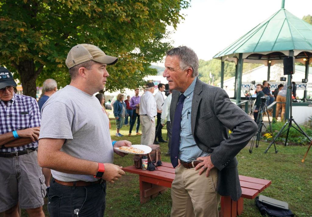 Vermont Governor Phil Scott greets voters following a debate with Vermont Democratic gubernatorial challenger Christine Hallquist September 14, 2018 at the Tunbridge World's Fair in Tunbridge, Vermont. - Hallquist is the first openly transgender person nominated for governor by a major party in the United States, defying death threats to take the political fight to Donald Trump. (Photo by Don EMMERT / AFP)        (Photo credit should read DON EMMERT/AFP via Getty Images). Governor Phil Scott is a race car driver and Vermont set a COVID vaccination record.