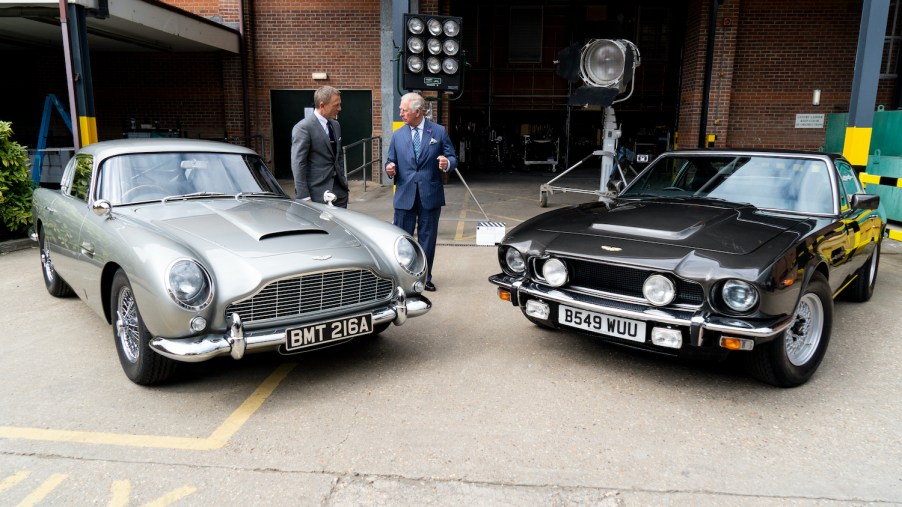 James Bond actor Daniel Craig showing Prince Charles two Aston Martin cars from No Time To Die