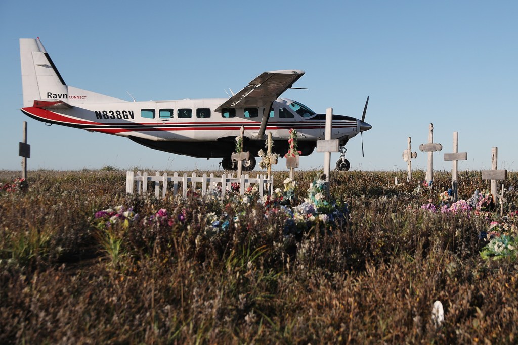A Ravn connect commuter plane in Alaska parked on the dirt runway in the town of Kivalina, next to the town's cemetary. Alaska has the highest rate of deadly plane crashes in the country. | Joe Raedle/Getty Images