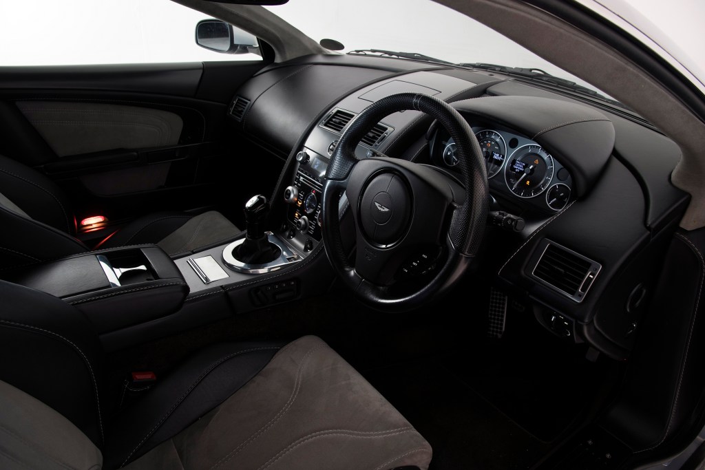 The interior of an Aston Martin DBS, complete with manual transmission