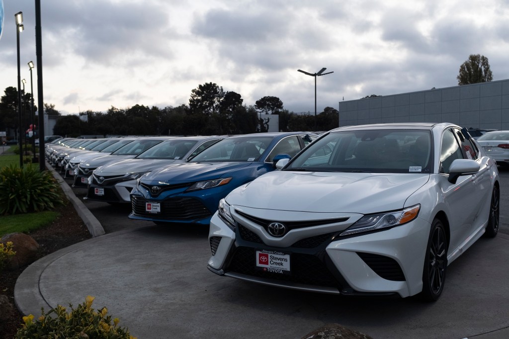 A row of Toyota Camry sedans at a dealership in California