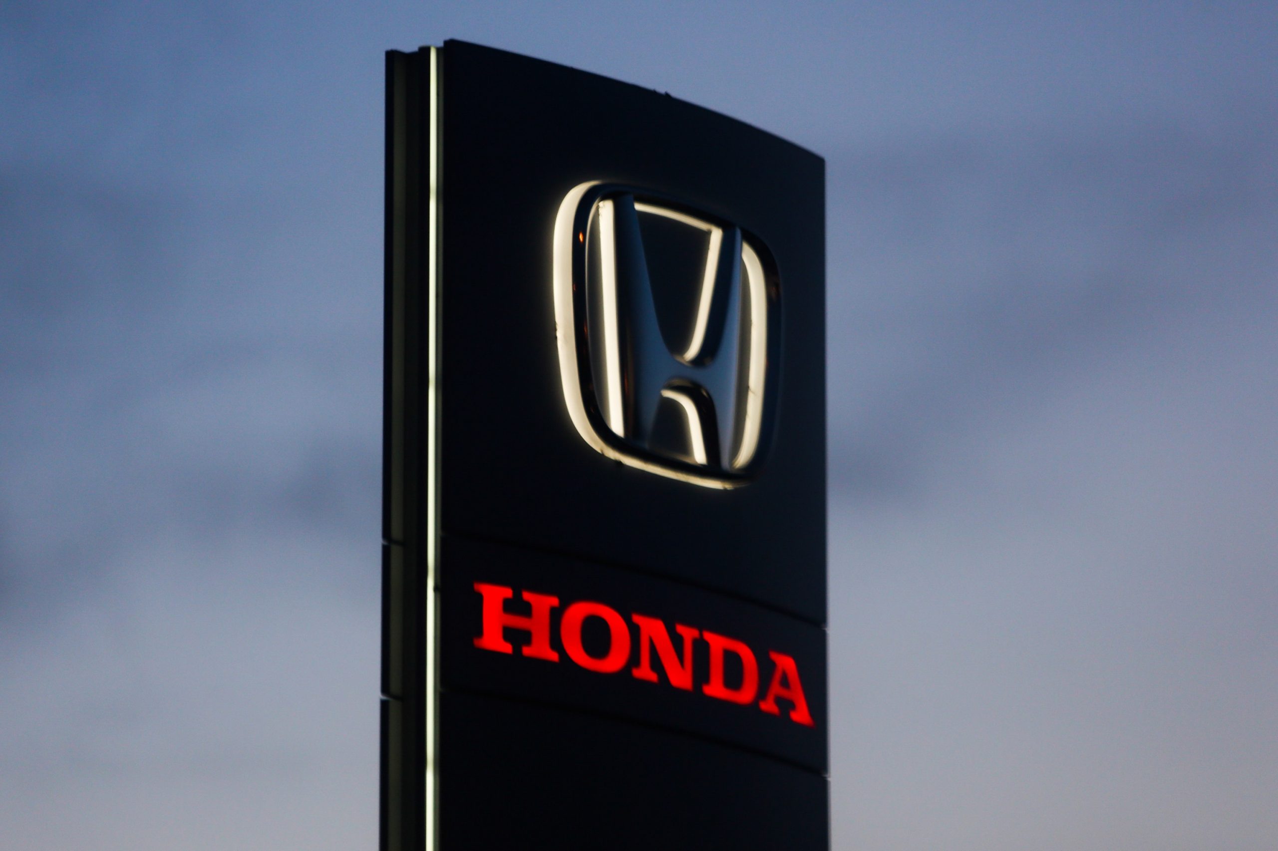 A red Honda Logo on a sign in Poland