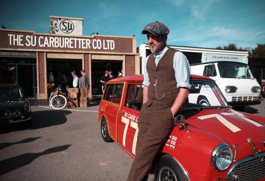 A participant leaning against a mini cooper during the Goodwood Revival at Goodwood on September 9, 2019 in Chichester, England. (Photo by Alex Livesey/Danehouse) find out the Goodwood Revival schedule and whether you have to dress up for the Goodwood Revival.