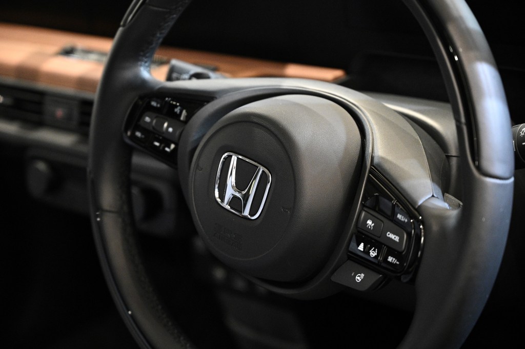 A Honda logo is pictured from a displayed car at a Honda showroom of company's headquarters in Tokyo.