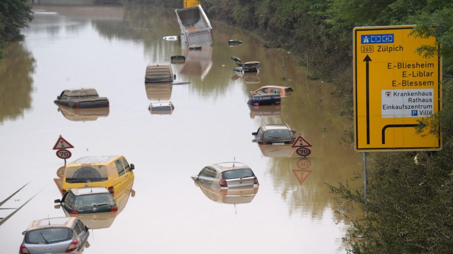 Cars wade through a flooded street in Germany
