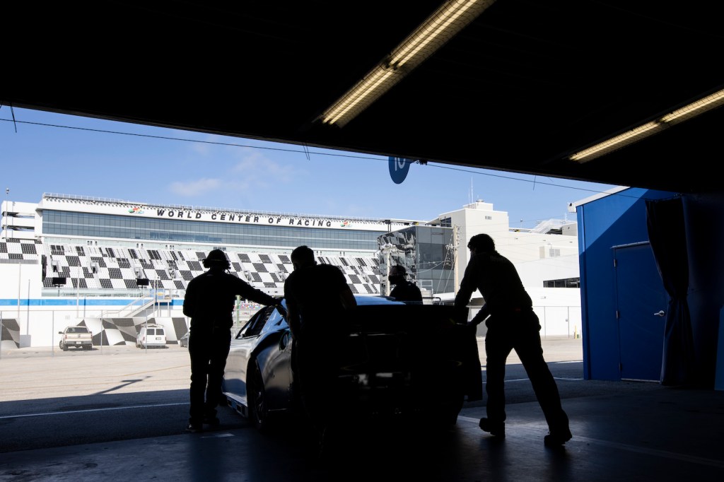 DAYTONA BEACH, FLORIDA - DECEMBER 15: Team members push the NASCAR Next Gen car out of the Garage during the NASCAR Cup Series test at Daytona International Speedway on December 15, 2020 in Daytona Beach, Florida. (Photo by James Gilbert/Getty Images). Next Gen NASCAR car.